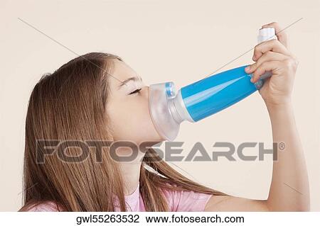 Girl using an asthma inhaler attached with spacer View Large Photo Image Stock Image - Girl using an asthma inhaler attached with spacer. Fotosearch