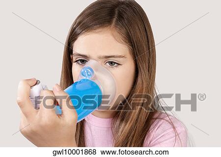 Girl using an asthma inhaler attached with spacer View Large Photo Image Stock Photo - Girl using an asthma inhaler attached with spacer. Fotosearch