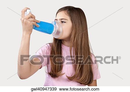 Girl using an asthma inhaler attached with spacer View Large Photo Image Stock Photo - Girl using an asthma inhaler attached with spacer. Fotosearch