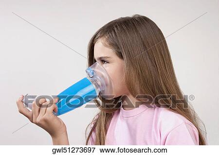 Girl using an asthma inhaler attached with a spacer View Large Photo Image Stock Photo - Girl using an asthma inhaler attached with a spacer. Fotosearch