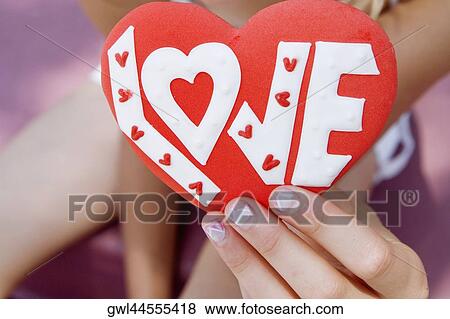 Girl's hand holding a valentine card View Large Photo Image Stock Photo - Girl's hand holding a valentine card. Fotosearch