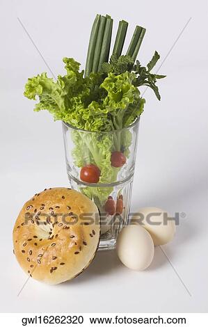 Glass full of vegetables with a bagel and brown eggs View Large Photo Image Stock Image - Glass full of vegetables with a bagel and brown eggs. Fotosearch