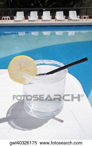 Glass of lemonade at the poolside View Large Photo Image Stock Photography - Glass of lemonade at the poolside. Fotosearch