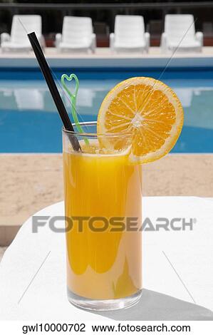 Glass of orange juice at the poolside View Large Photo Image Stock Image - Glass of orange juice at the poolside. Fotosearch