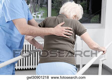 Health worker assisting a disabled woman in walking View Large Photo Image Stock Photo - Health worker assisting a disabled woman in walking. Fotosearch