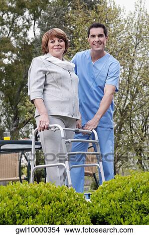 Health worker standing with a disabled woman View Large Photo Image Picture - Health worker standing with a disabled woman. Fotosearch