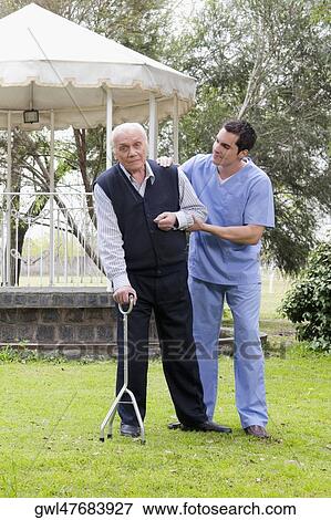 Stock Photo - Healthcare worker assisting a patient in walking. Fotosearch