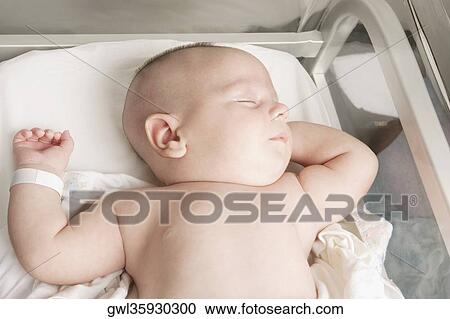 High angle view of a newborn baby sleeping View Large Photo Image Stock Image - High angle view of a newborn baby sleeping. Fotosearch