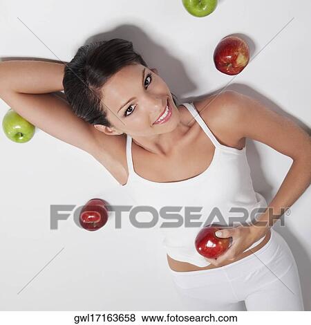High angle view of a woman lying with red and green apples View Large Photo Image Stock Photo - High angle view of a woman lying with red and green apples. Fotosearch