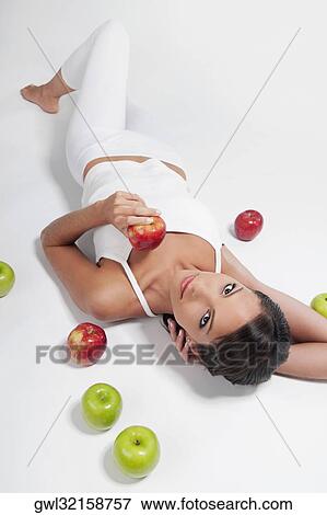 High angle view of a woman lying with red and green apples View Large Photo Image Stock Photo - High angle view of a woman lying with red and green apples. Fotosearch