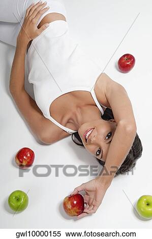 High angle view of a woman lying with red and green apples View Large Photo Image Stock Photography - High angle view of a woman lying with red and green apples. Fotosearch