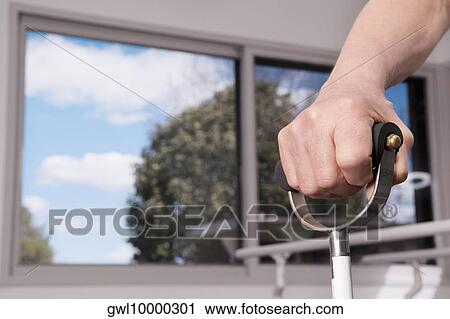 Human hand holding a crutch View Large Photo Image Stock Image - Human hand holding a crutch. Fotosearch