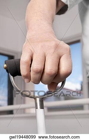 Human hand holding a crutch View Large Photo Image Stock Photo - Human hand holding a crutch. Fotosearch