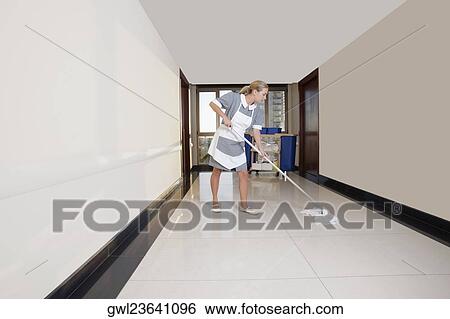 Janitor cleaning the corridor of a hospital View Large Photo Image Stock Photograph - Janitor cleaning the corridor of a hospital. Fotosearch