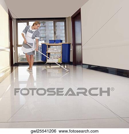 Stock Photograph - Janitor cleaning the corridor of a hospital. Fotosearch