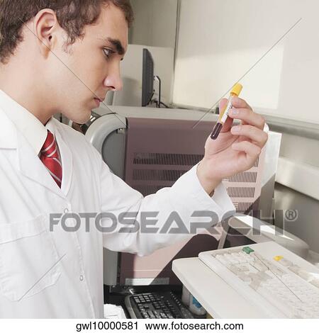Lab technician analyzing a blood sample in a test tube View Large Photo Image Stock Image - Lab technician analyzing a blood sample in a test tube. Fotosearch