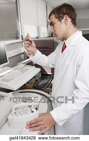 Lab technician analyzing a blood sample in a test tube View Large Photo Image Stock Photo - Lab technician analyzing a blood sample in a test tube. Fotosearch
