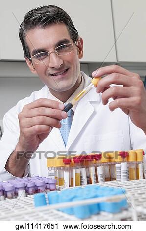 Lab technician analyzing sample in a test tube View Large Photo Image Stock Image - Lab technician analyzing sample in a test tube. Fotosearch