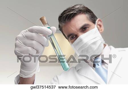 Lab technician analyzing sample in a test tube View Large Photo Image Stock Photo - Lab technician analyzing sample in a test tube. Fotosearch