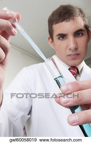 Lab technician analyzing sample in a test tube View Large Photo Image Stock Photo - Lab technician analyzing sample in a test tube. Fotosearch
