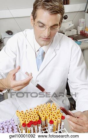 Lab technician filling blood in a test tube from a syringe View Large Photo Image Stock Image - Lab technician filling blood in a test tube from a syringe. Fotosearch
