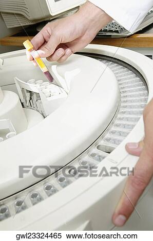 Stock Photography - Lab technician putting blood sample in the laboratory freezer. Fotosearch