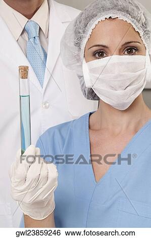Lab technicians analyzing a sample in a test tube View Large Photo Image Stock Photograph - Lab technicians analyzing a sample in a test tube. Fotosearch