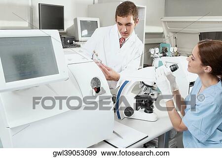 Lab technicians working in a laboratory View Large Photo Image Stock Photo - Lab technicians working in a laboratory. Fotosearch