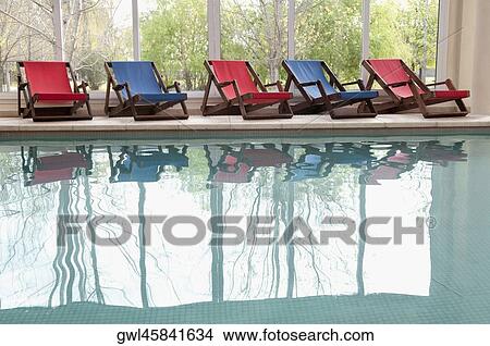 Lounge chairs at poolside in a rehabilitation center View Large Photo Image Picture - Lounge chairs at poolside in a rehabilitation center. Fotosearch