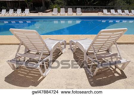 Picture - Lounge chairs at the poolside. Fotosearch