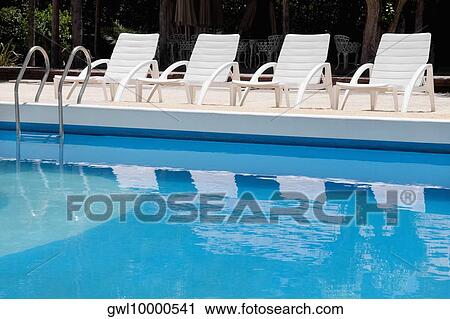 Lounge chairs at the poolside View Large Photo Image Stock Image - Lounge chairs at the poolside. Fotosearch