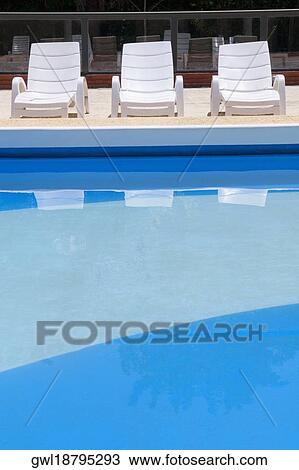 Lounge chairs at the poolside View Large Photo Image Stock Image - Lounge chairs at the poolside. Fotosearch