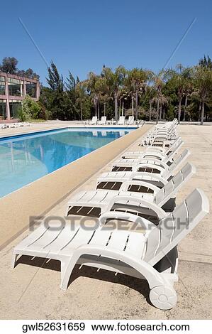 Lounge chairs at the poolside View Large Photo Image Stock Photo - Lounge chairs at the poolside. Fotosearch
