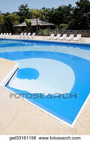 Stock Photograph - Lounge chairs at the poolside. Fotosearch