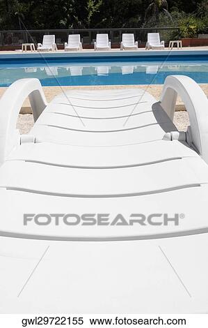 Lounge chairs at the poolside View Large Photo Image Stock Photography - Lounge chairs at the poolside. Fotosearch
