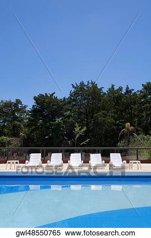 Lounge chairs at the poolside View Large Photo Image Stock Photography - Lounge chairs at the poolside. Fotosearch