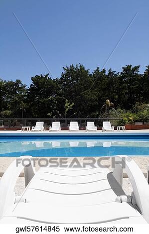 Lounge chairs at the poolside View Large Photo Image Stock Photography - Lounge chairs at the poolside. Fotosearch