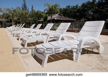 Lounge chairs in a row View Large Photo Image Stock Photo - Lounge chairs in a row. Fotosearch