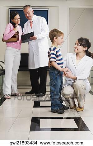 Male and a female doctor with patients View Large Photo Image Picture - Male and a female doctor with patients. Fotosearch