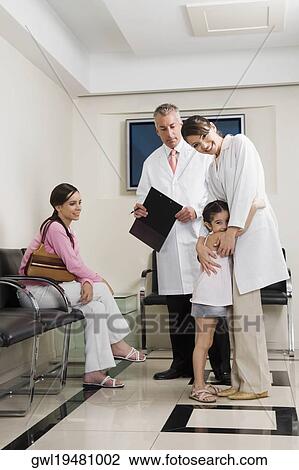 Male and a female doctor with patients View Large Photo Image Stock Image - Male and a female doctor with patients. Fotosearch