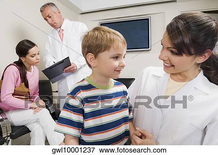 Male and a female doctor with patients View Large Photo Image Stock Photo - Male and a female doctor with patients. Fotosearch