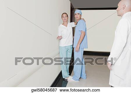 Male nurse flirting with a female nurse in hospital corridor View Large Photo Image Stock Photo - Male nurse flirting with a female nurse in hospital corridor. Fotosearch