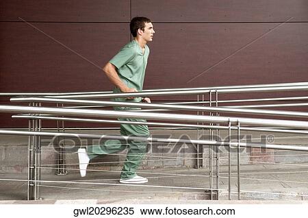 Male nurse running in a hospital View Large Photo Image Stock Photography - Male nurse running in a hospital. Fotosearch