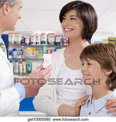 Male pharmacist giving medicine to customers View Large Photo Image Stock Image - Male pharmacist giving medicine to customers. Fotosearch