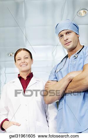 Male surgeon and a female doctor standing together and smiling View Large Photo Image Stock Photography - Male surgeon and a female doctor standing together and smiling. Fotosearch