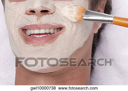 Stock Photo - Man applying face pack. Fotosearch