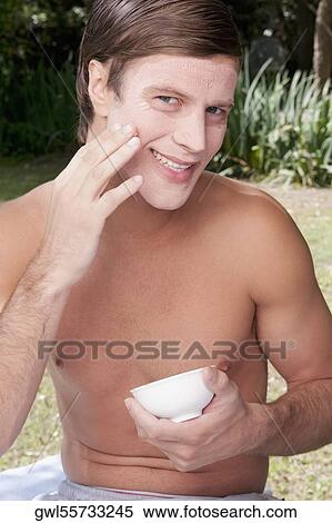 Stock Photography - Man applying face pack. Fotosearch
