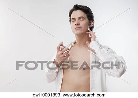 Man applying perfume View Large Photo Image Stock Image - Man applying perfume. Fotosearch