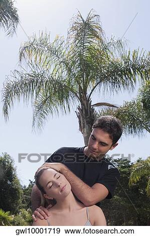 Man assisting a woman during yoga practice View Large Photo Image Stock Photo - Man assisting a woman during yoga practice. Fotosearch