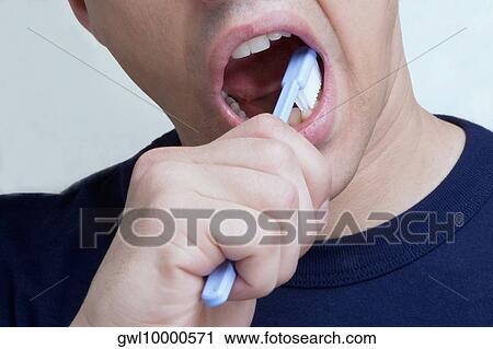 Stock Image - Man brushing teeth. Fotosearch